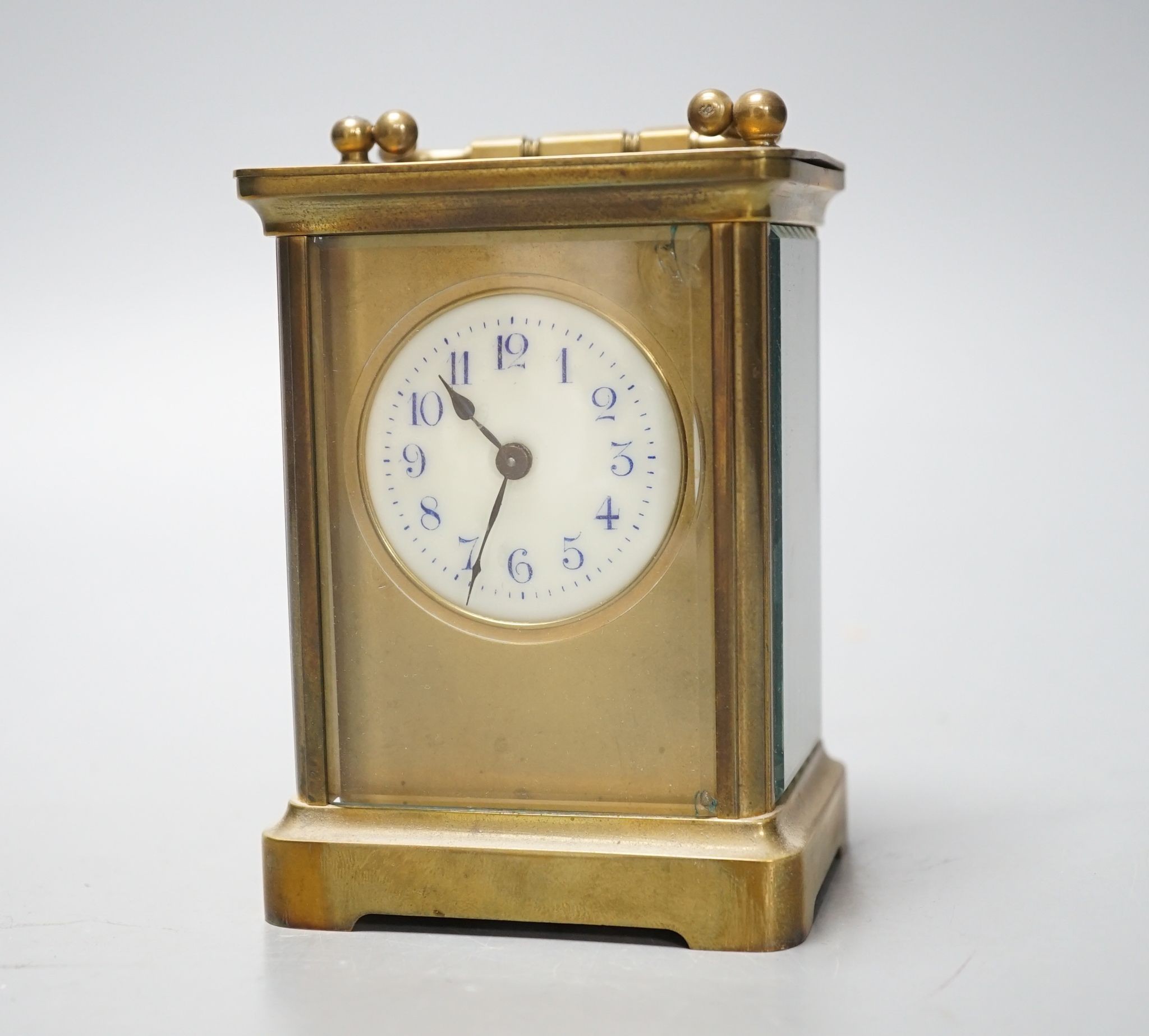 A cased brass carriage timepiece, 10.5 cms high high not including case.